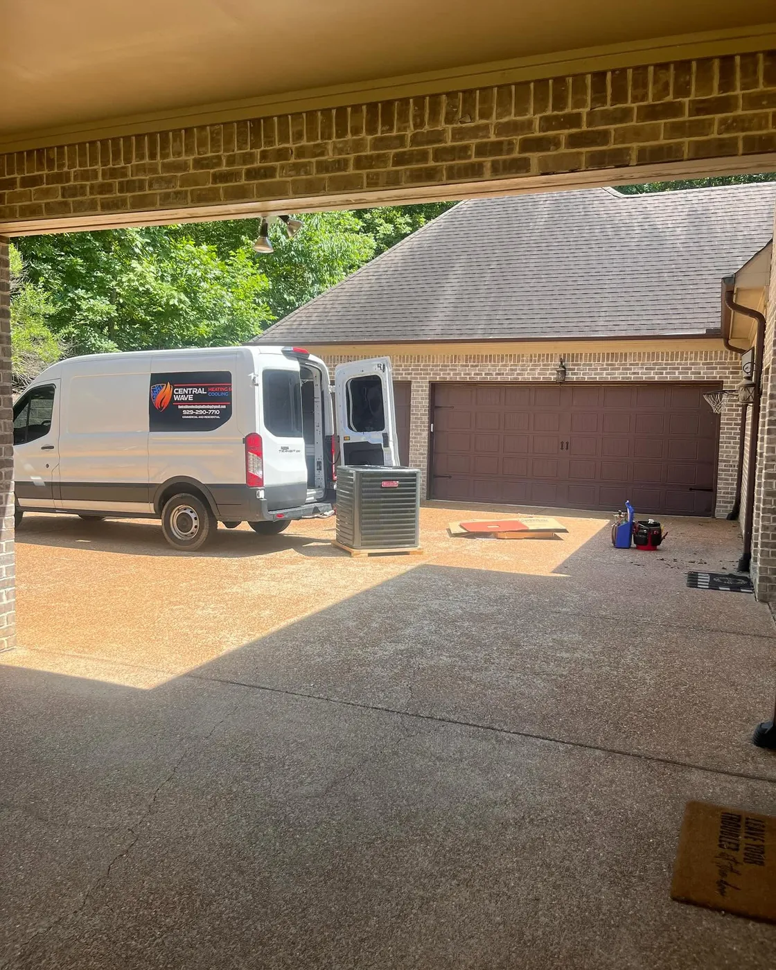 Central Wave work van in a driveway beside a new outdoor condenser